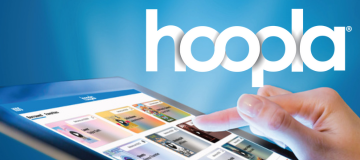 A hand scrolling through the Hoopla app on a tablet.