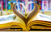 An open book, with pages curled to form a heart. 